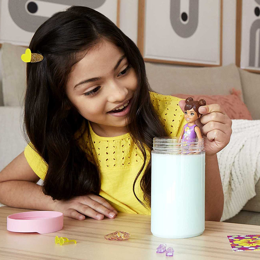 Barbie Chelsea Color Reveal Doll with 6 Surprises: 4 Bags with Cover-Up, Shoes, Towel & Accessory; Water Reveals Marble Blue Doll’s Look & Color Change on Hair; Sand & Sun Series